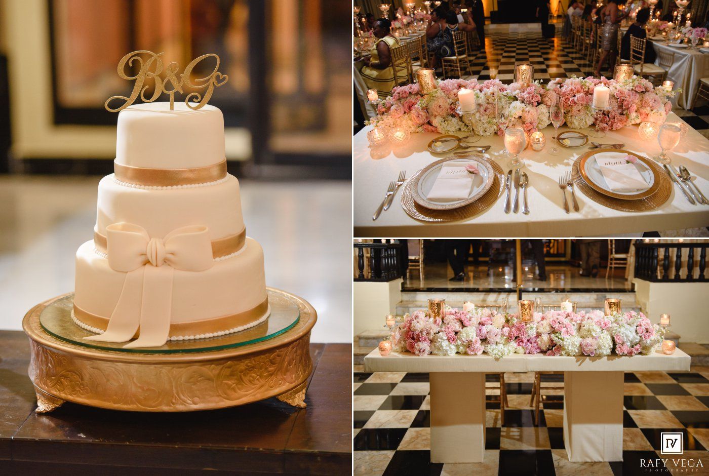 Elegant four-tier white wedding cake with bow on gold stand beside floral centerpiece table setting with candles.