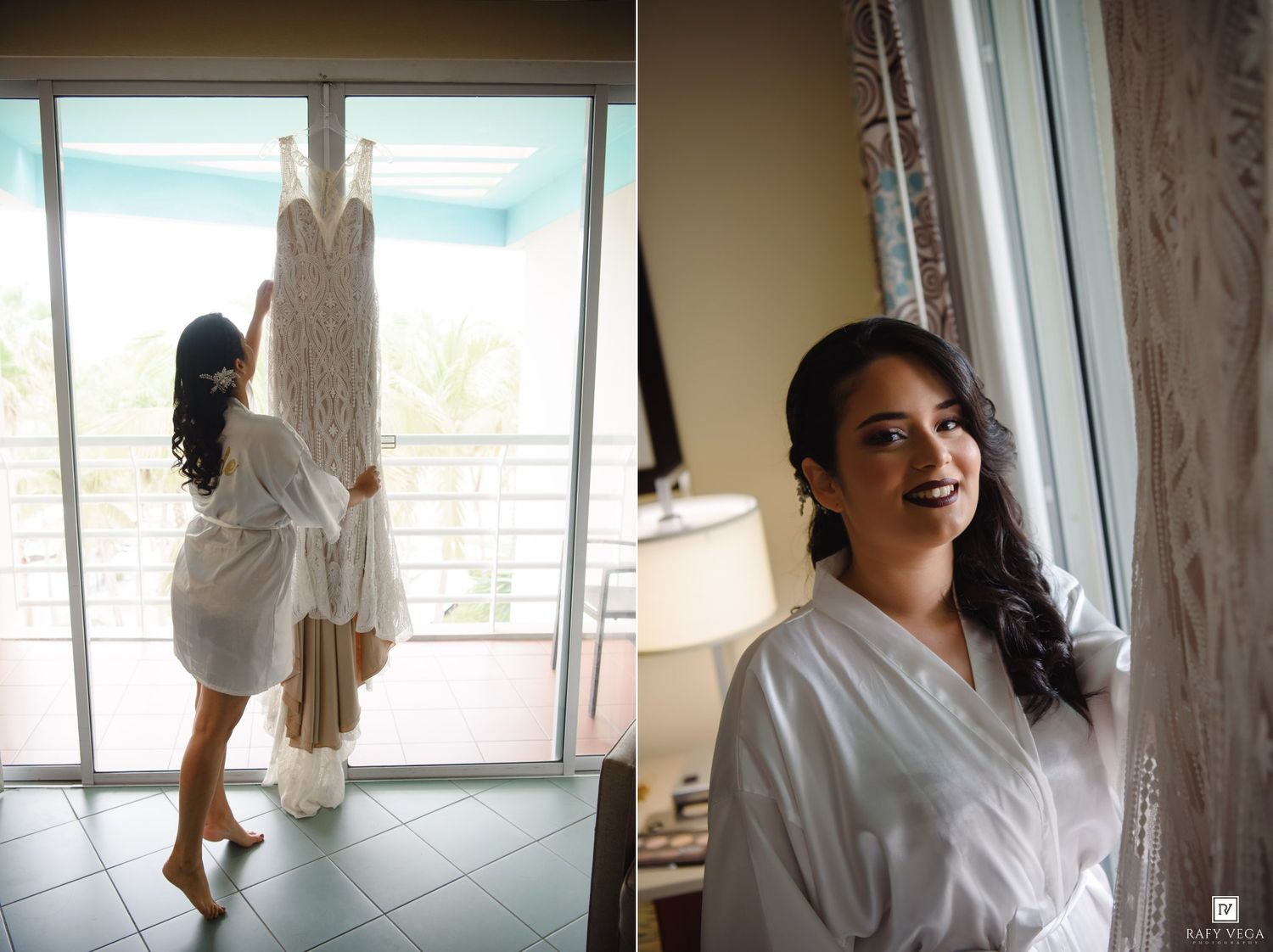 Bride in white robe holding wedding dress by window, smiling bridal portrait in hotel room on wedding day.