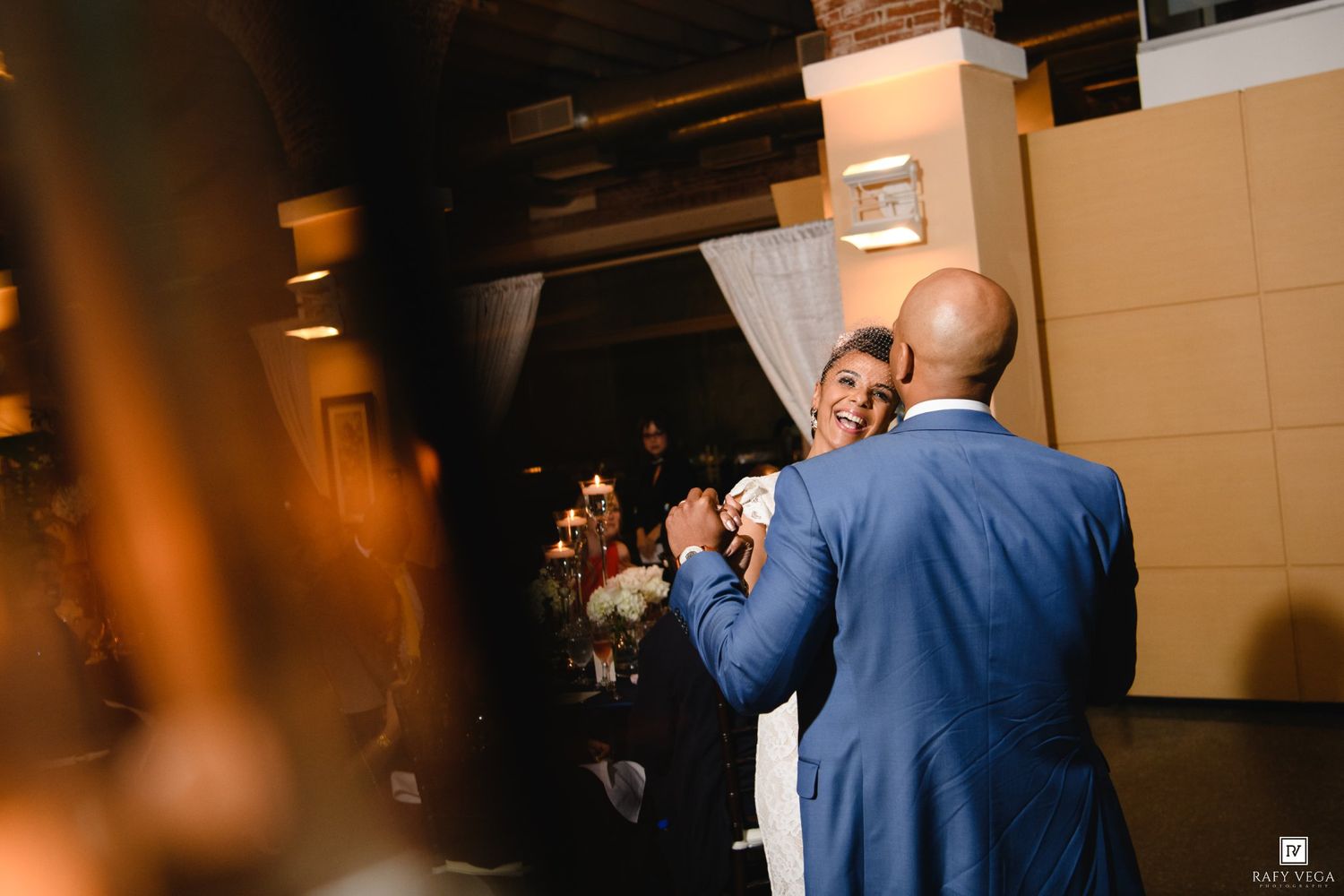 Bride and groom share a joyful first dance at their elegant wedding reception venue.
