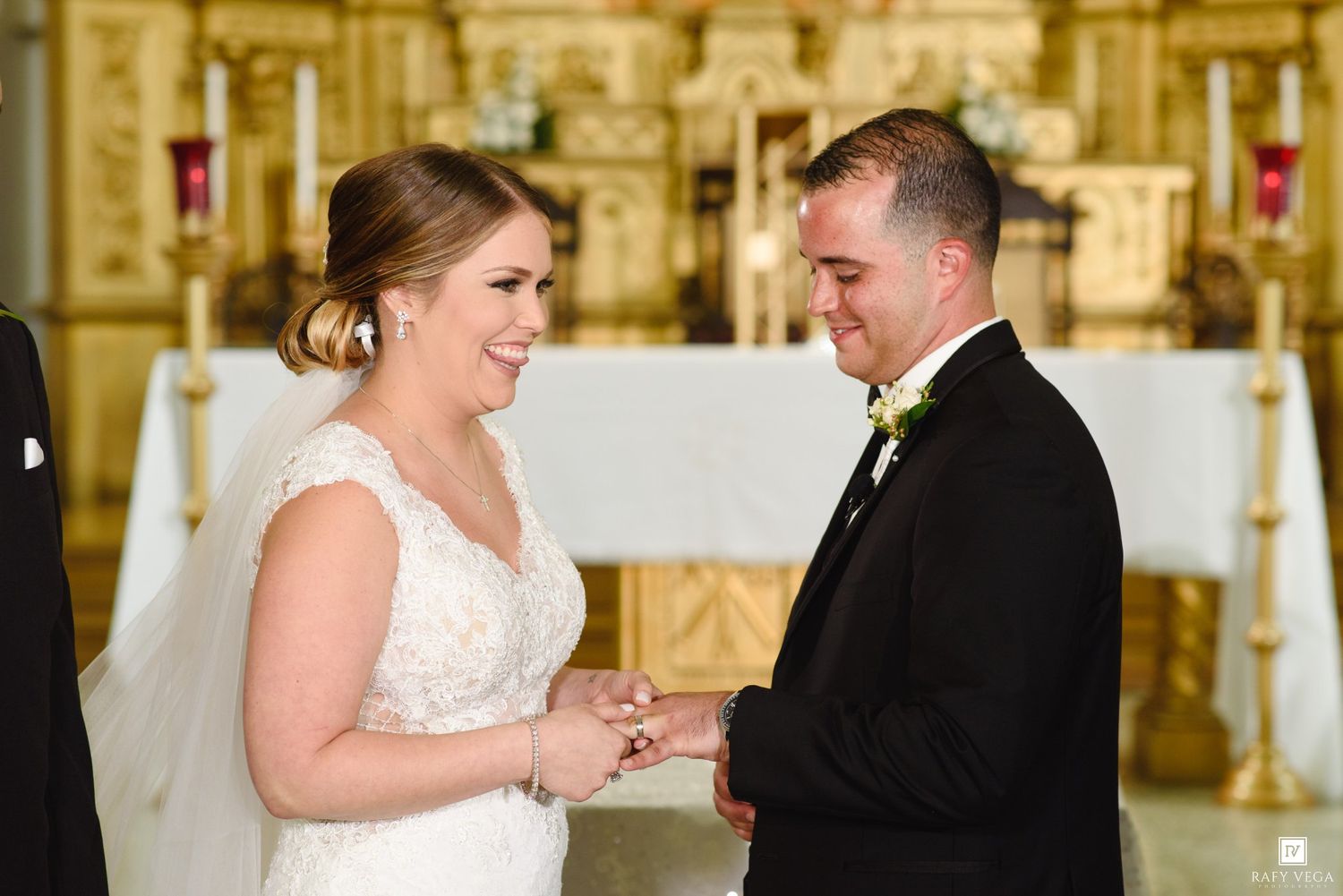 Bride and groom exchanging rings at church altar during wedding ceremony.