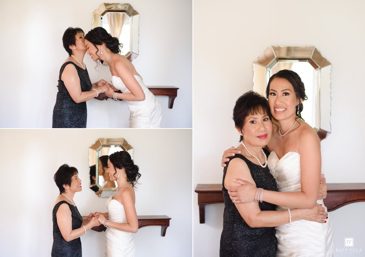 Bride in white gown with older woman in black dress helping her prepare, posing together near mirror.