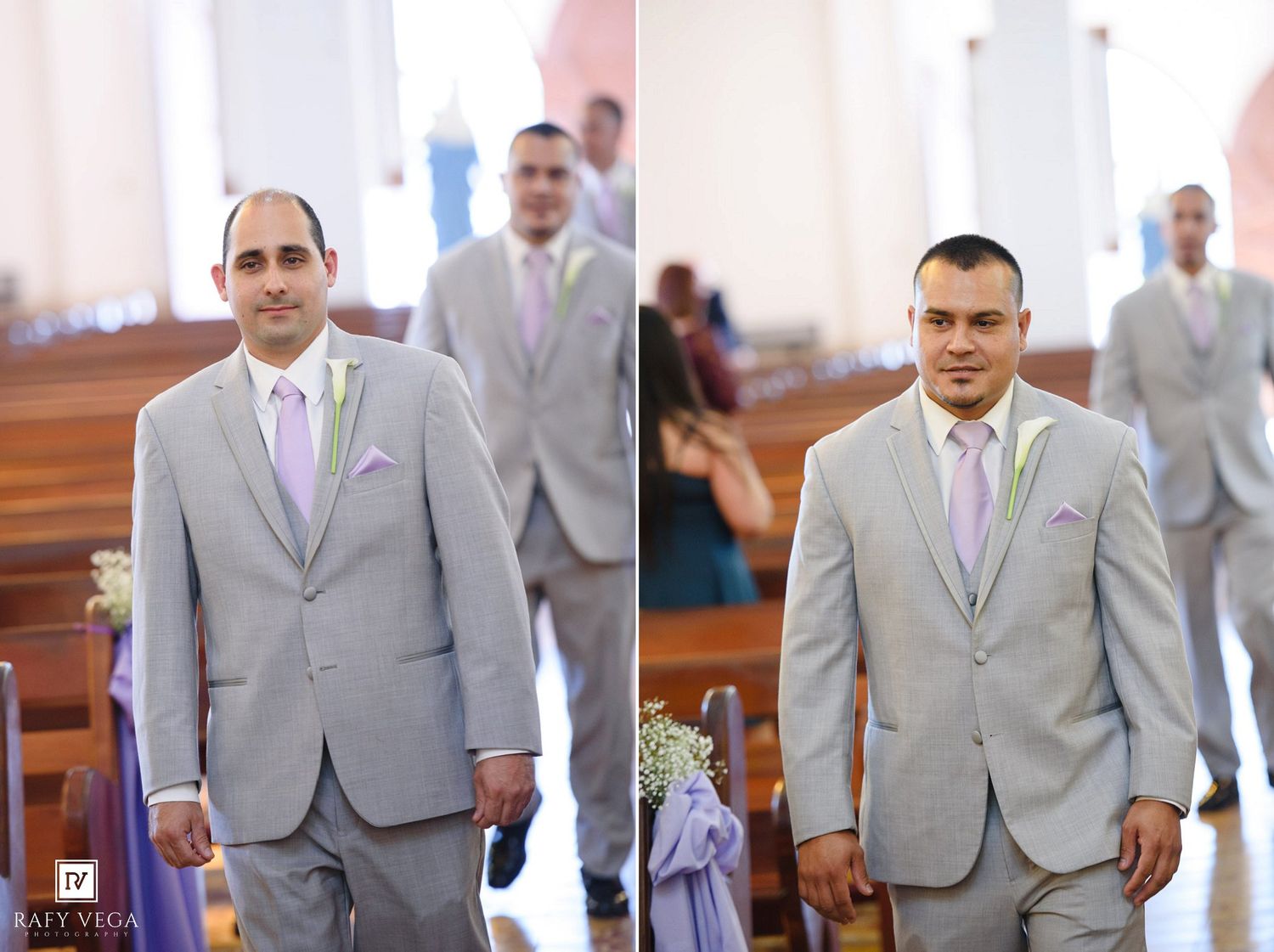 Two groomsmen in gray suits with lavender ties stand in a church aisle during a wedding ceremony.