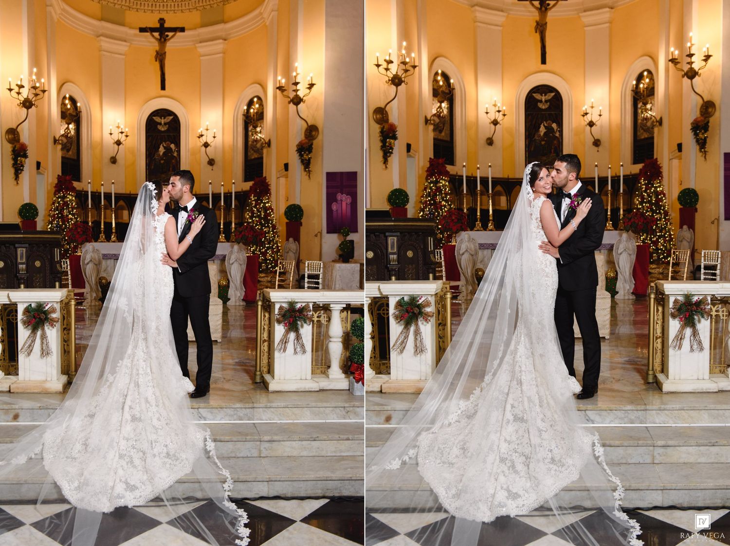 Bride and groom share a romantic kiss at the altar of an elegantly decorated church with Christmas trees.