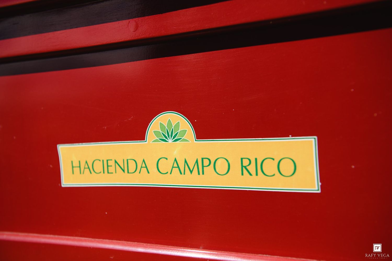 Hacienda Campo Rico logo sign on a red background with green agave plant emblem.