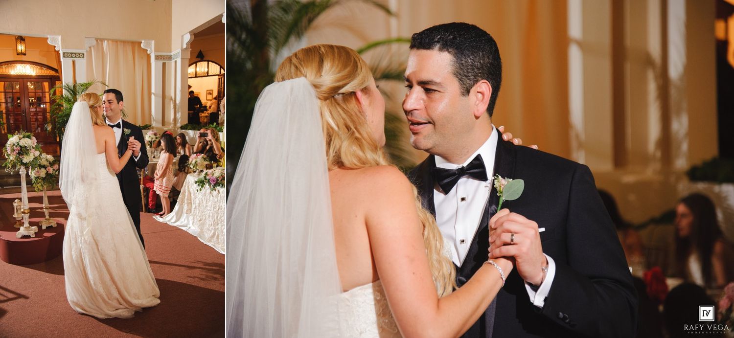 Bride and groom share their first dance at elegant wedding reception, bride in white gown with veil, groom in black tuxedo.