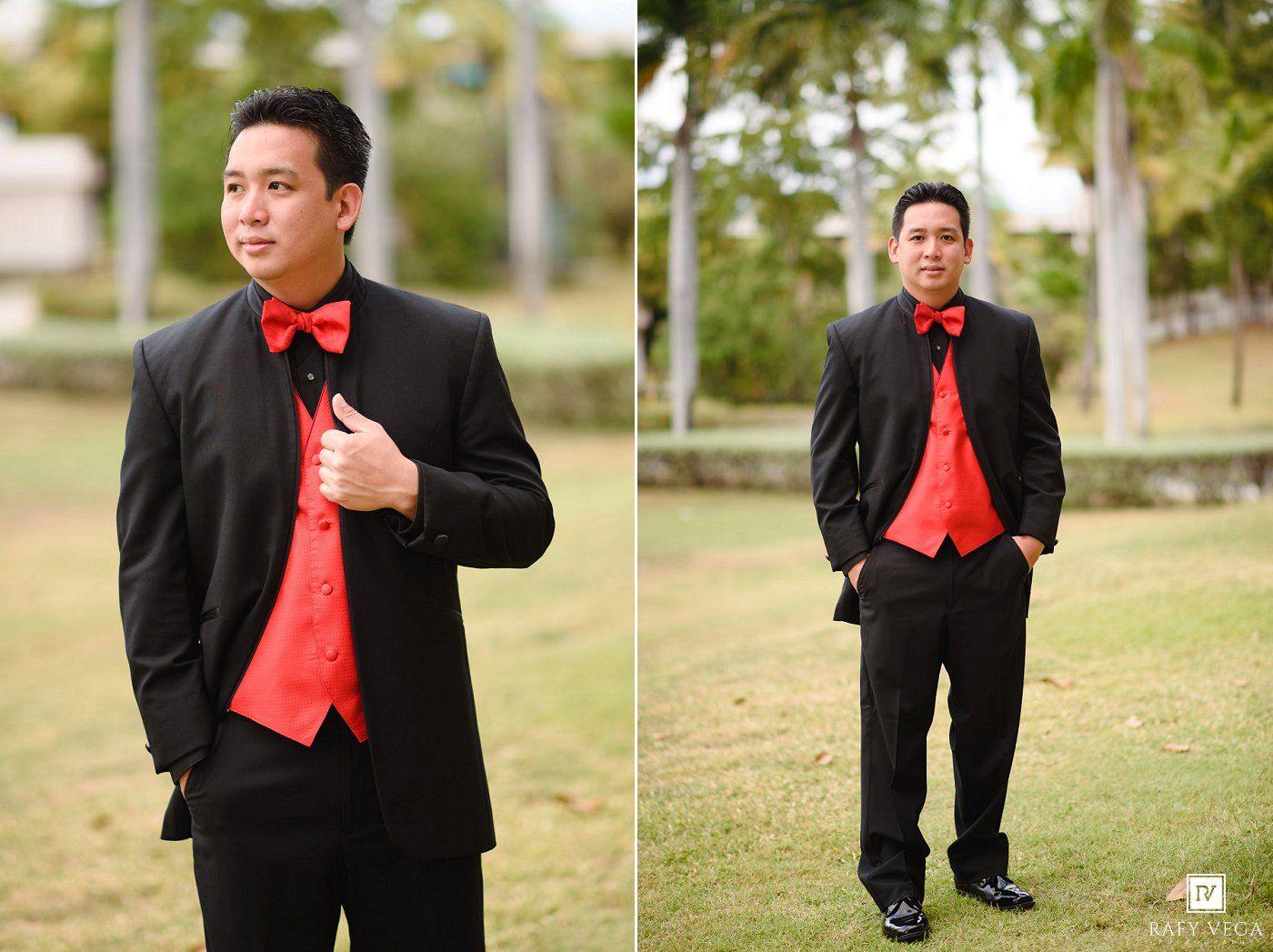Man in black tuxedo with red bow tie and vest posing outdoors on green grass for formal portrait.