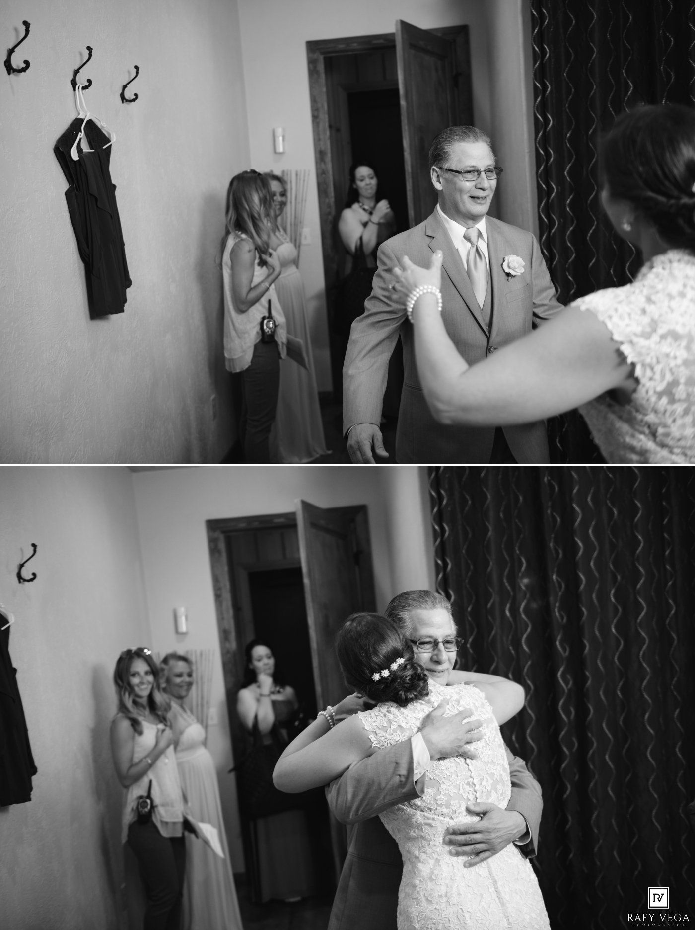 Black and white wedding photo of father seeing bride for first time, sharing emotional hug while guests watch.