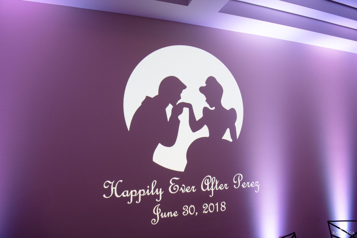Happily Ever After Perez June 30 2018 wedding logo projected on wall with romantic silhouette design.