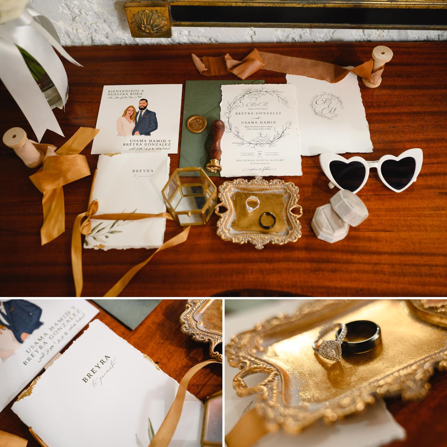 Elegant wedding flat lay with invitation suite, heart sunglasses, gold tray, rings, and ribbon on a wooden surface.