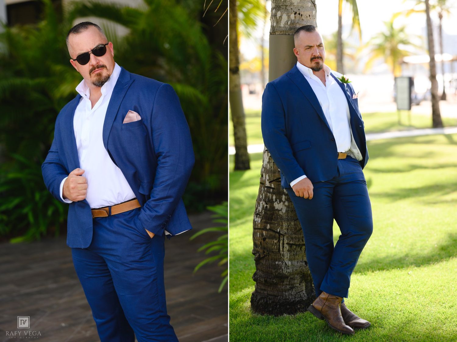 Man in blue suit, white shirt, sunglasses, and brown belt poses outdoors near palm trees on green grass.