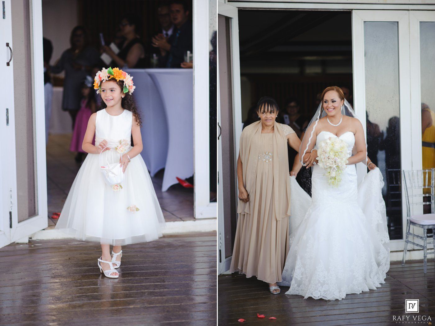 Flower girl in white dress with floral crown leads bride in lace gown down the aisle at outdoor wedding.