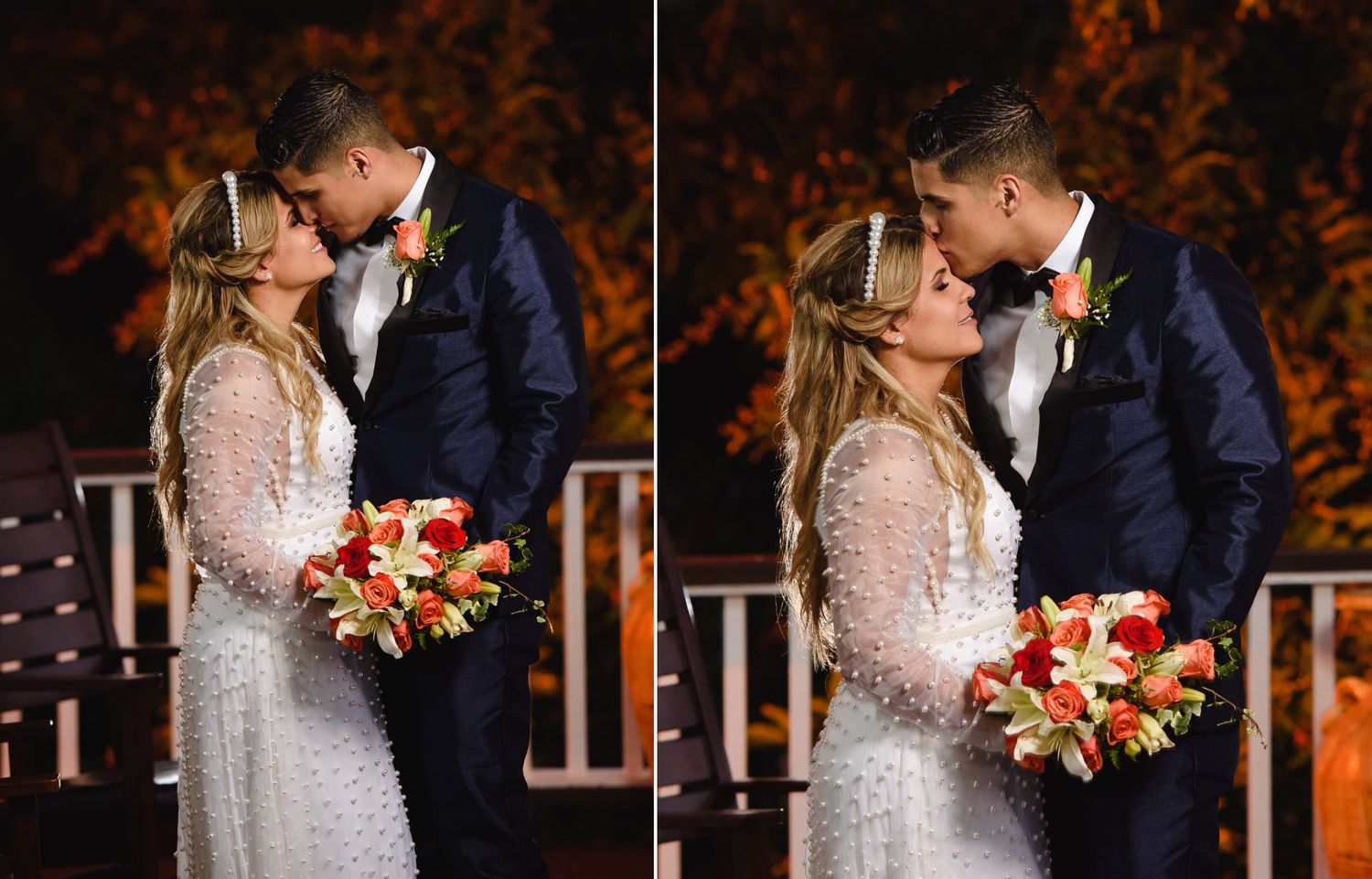 Bride and groom share a romantic kiss at night, bride holding vibrant red and orange bouquet in white lace gown.