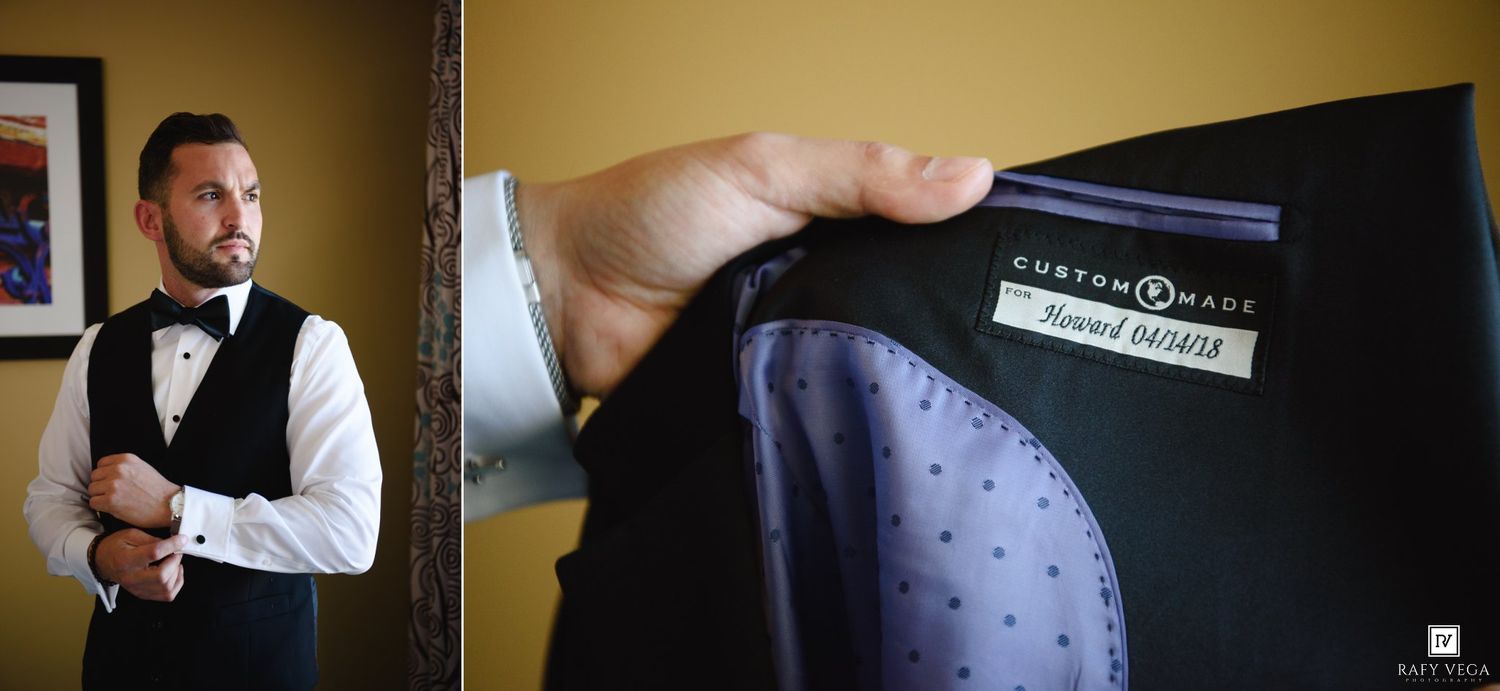 Groom adjusting cufflinks beside a Custom Haus suit jacket with a personalized name label on display.
