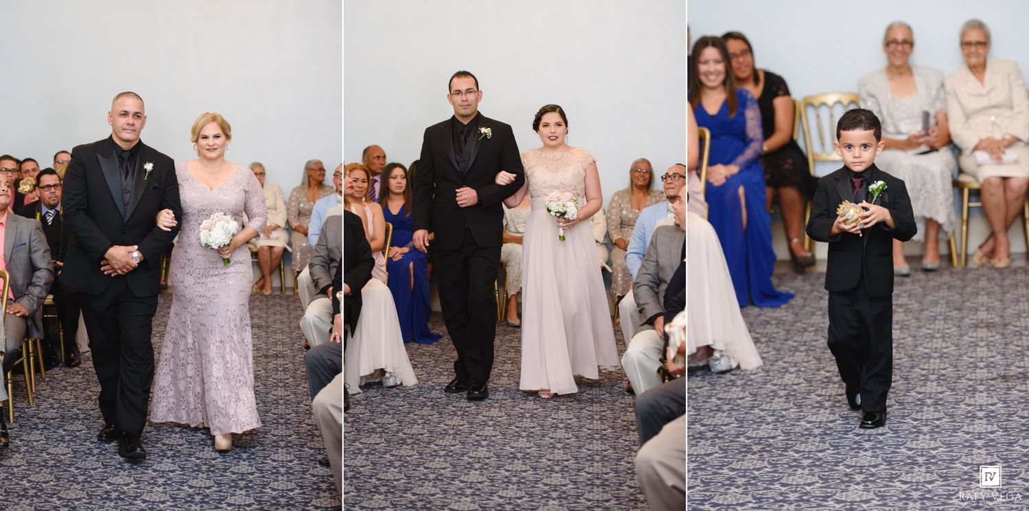 Wedding processional with bridal party walking down the aisle in elegant gowns at a formal ceremony.