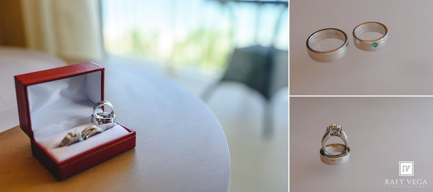 Wedding rings displayed in a red box and on a white surface, featuring a diamond engagement ring and two gold bands.