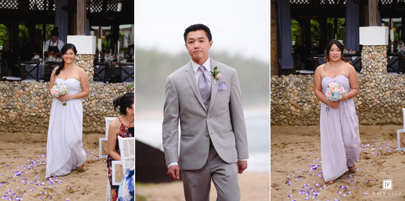 Wedding party on beach with groom in gray suit and bridesmaids in lavender dresses during outdoor ceremony.