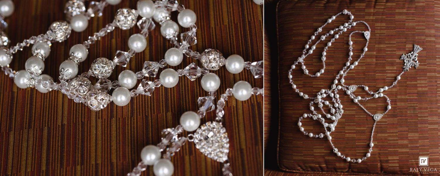 Elegant pearl and crystal beaded necklace with rhinestone accents displayed on wooden surface beside a delicate star charm rosary.