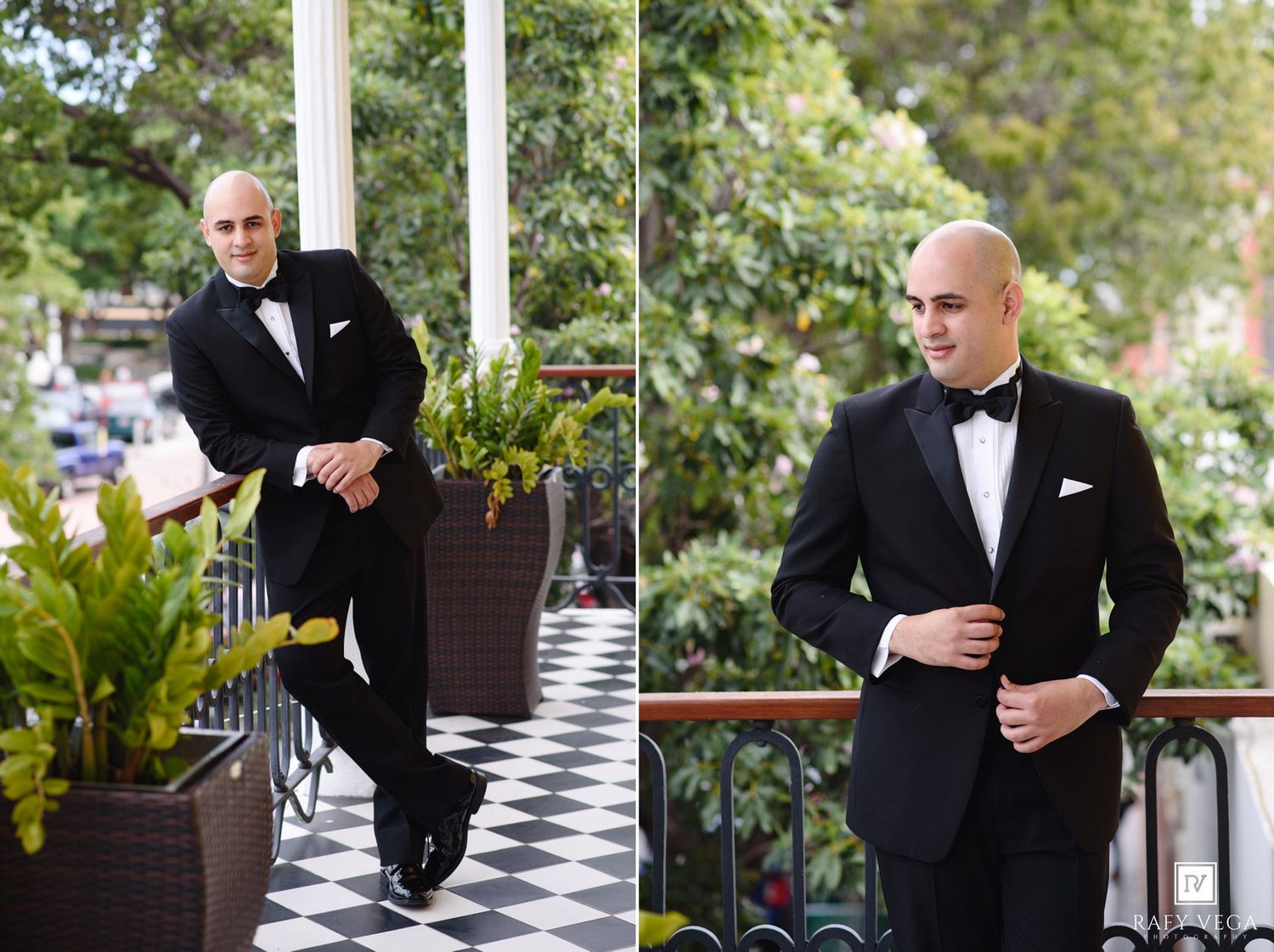 Groom in black tuxedo and bow tie posing on a balcony with checkered floor and lush green trees.