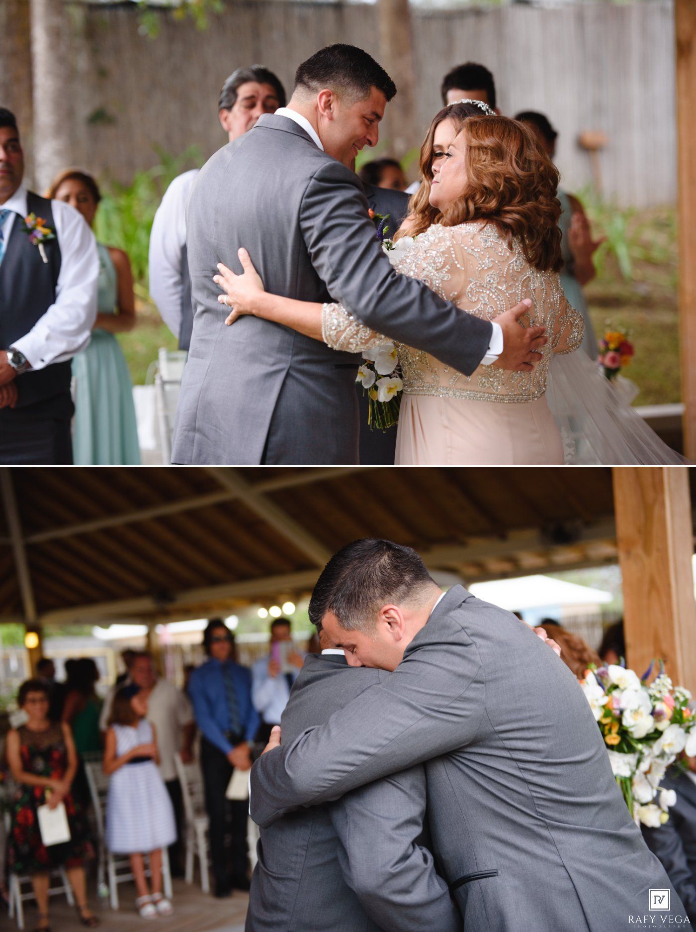 Emotional wedding ceremony moment as bride and groom embrace, with tearful hug shared between groom and father near floral arrangements.