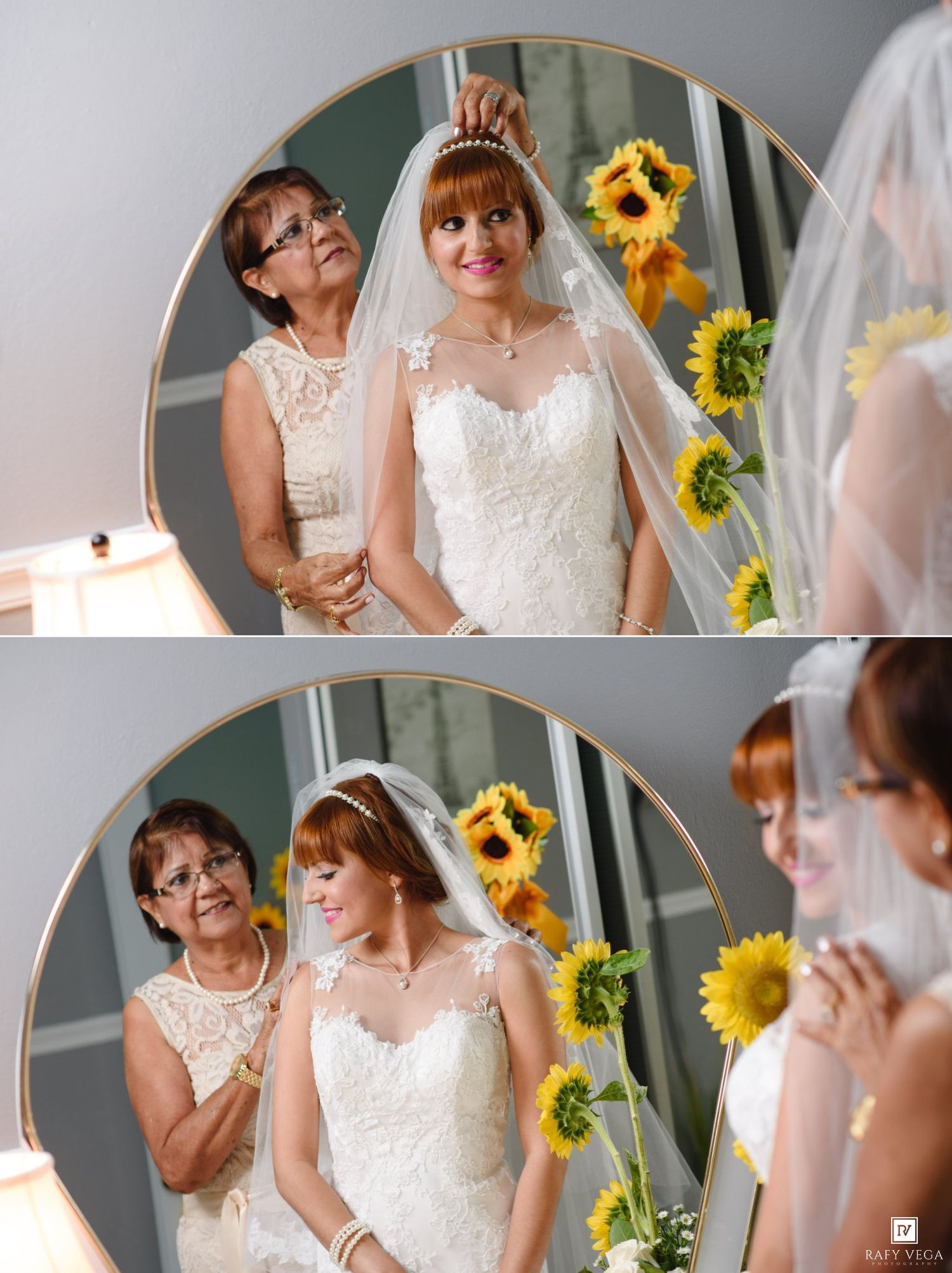 Bride in lace wedding gown with veil being crowned by older woman, reflected in a round mirror.