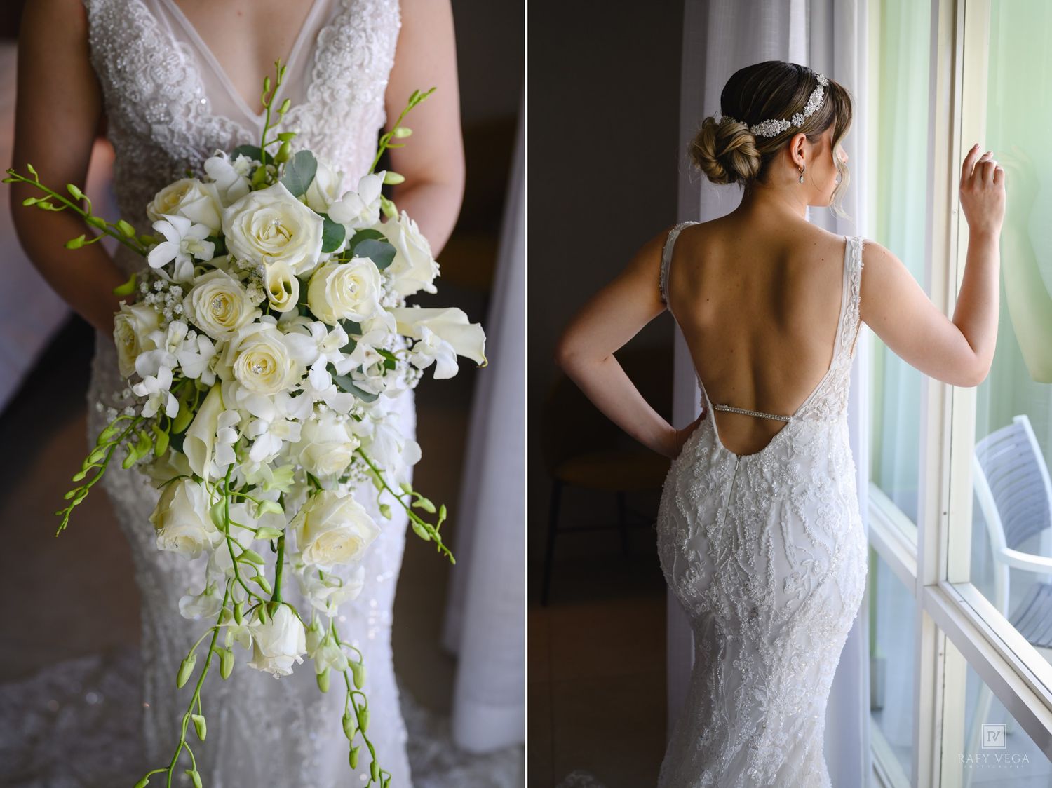 Bride holding cascading white rose bouquet beside a backless lace wedding gown with spaghetti straps near a window.