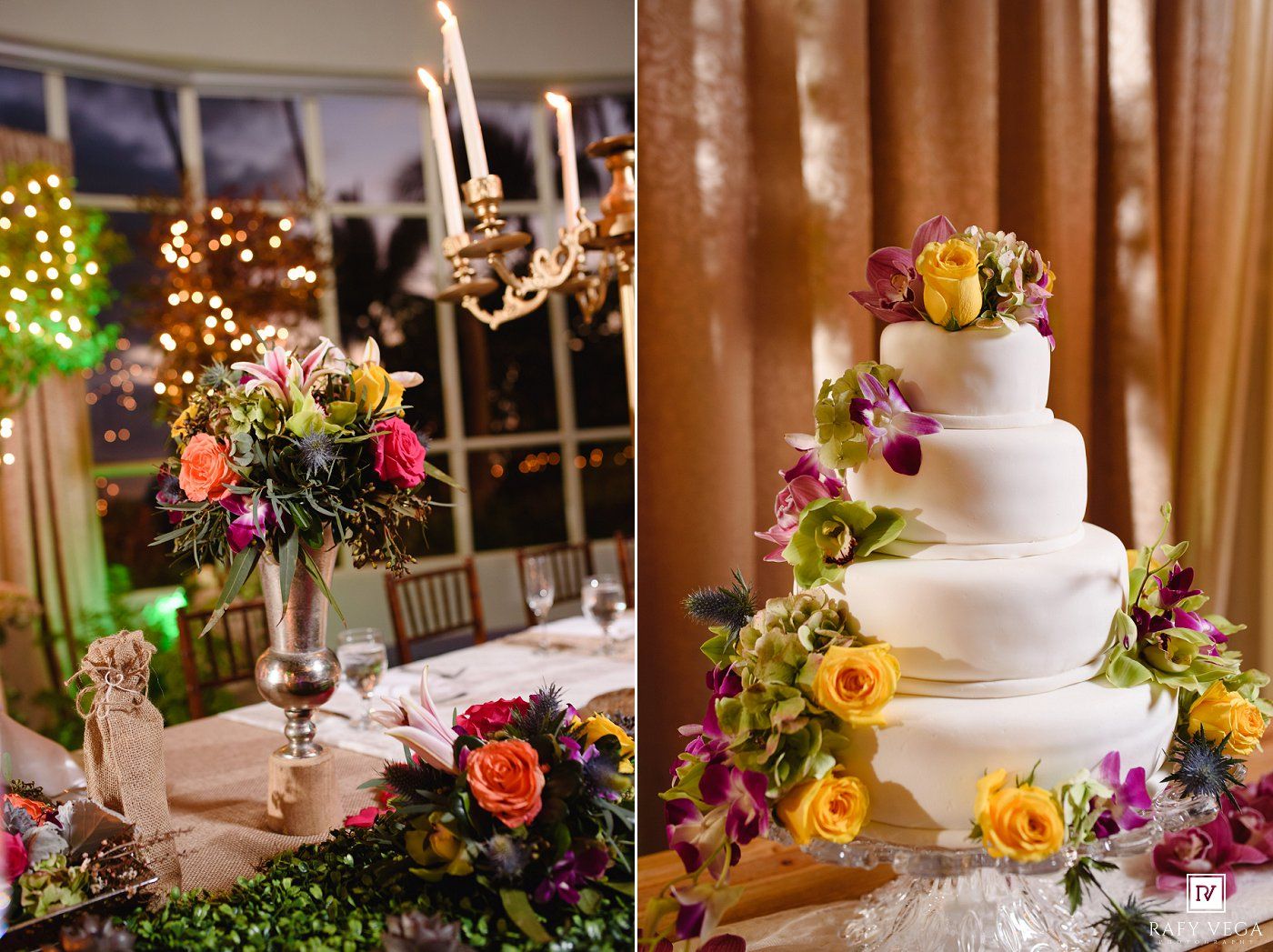 Vibrant wedding cake with yellow roses and purple orchids beside lush floral centerpieces in a warmly lit reception venue.