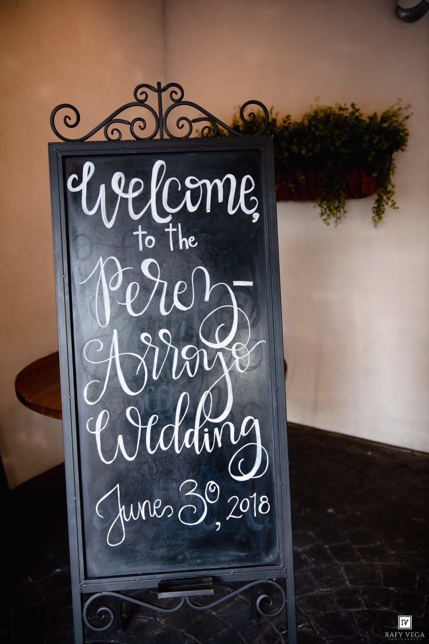 Elegant chalkboard wedding welcome sign for the Perez-Arroyo Wedding on June 30, 2018, displayed on ornate black stand.