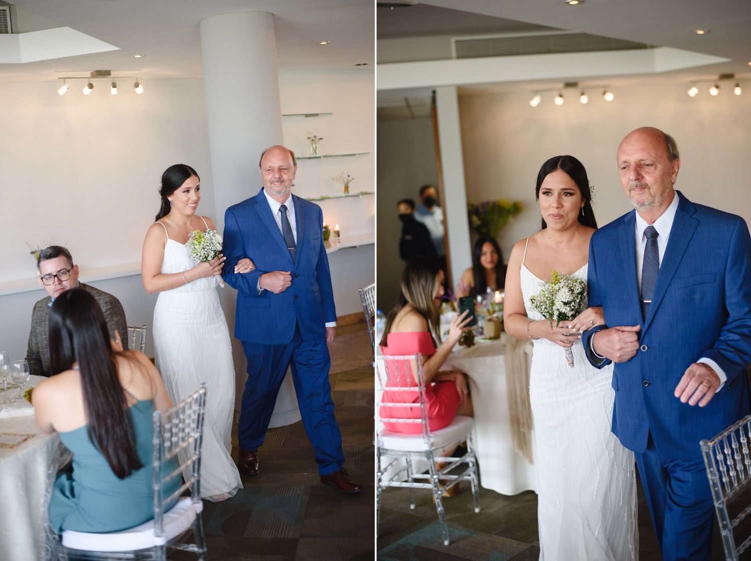 Bride in white gown walks down aisle with father in blue suit during indoor wedding ceremony.