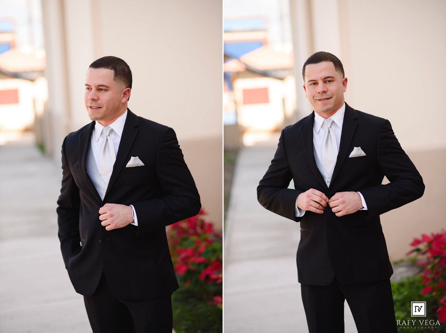 Groom in black tuxedo with white pocket square adjusting jacket outdoors near red flowers.