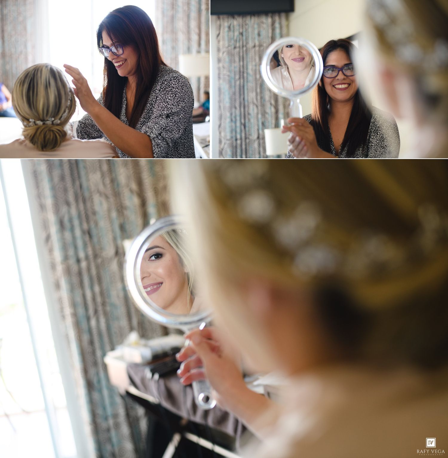Bride admiring her wedding hair and makeup in a handheld mirror while a stylist works nearby.