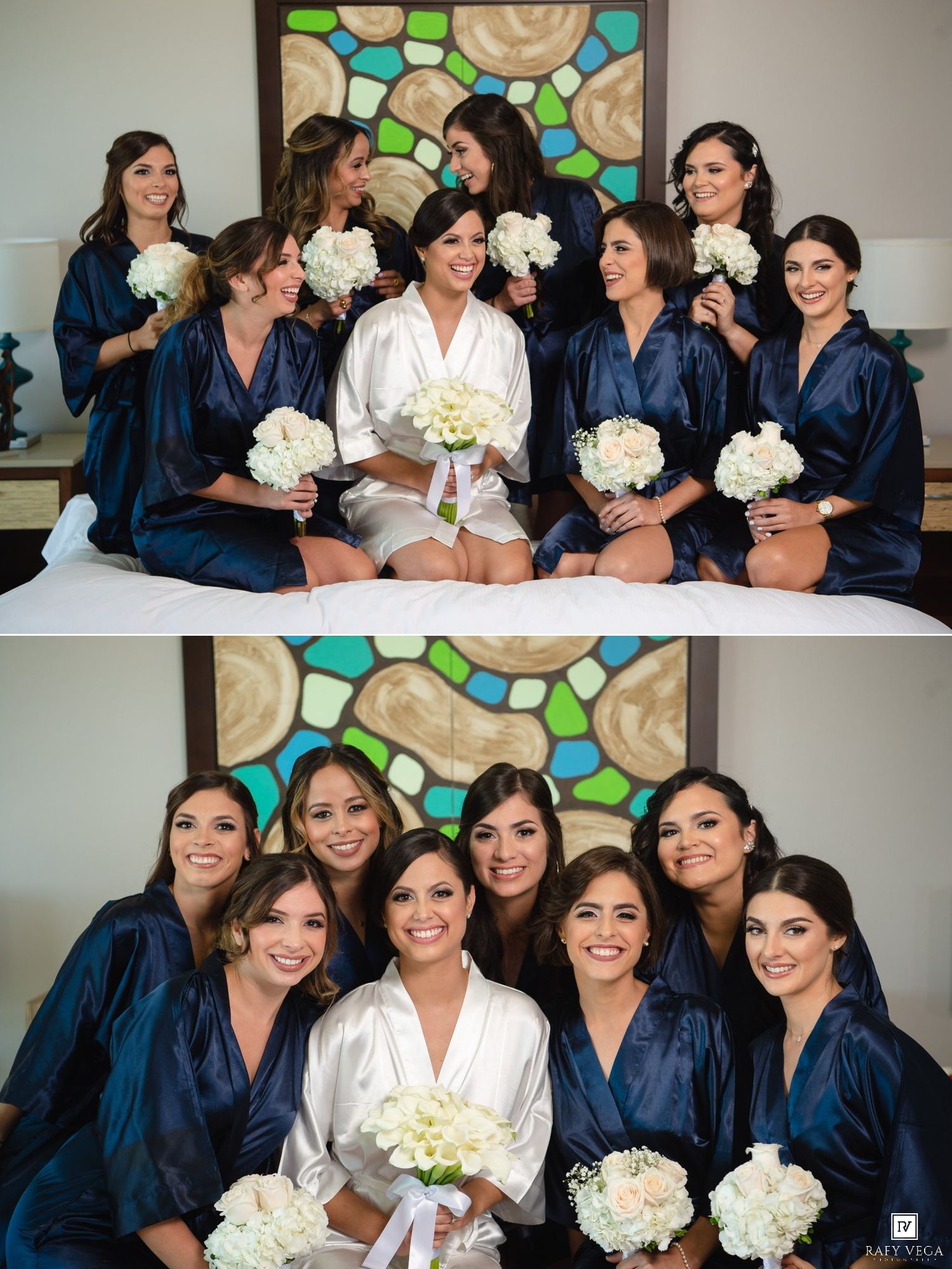 Bride in white robe with bridesmaids in navy robes holding white bouquets, posing on bed before wedding.