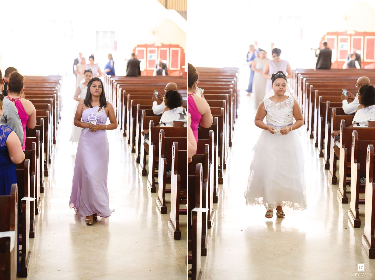 Bride and bridesmaid walking down church aisle during wedding ceremony with guests seated in pews.