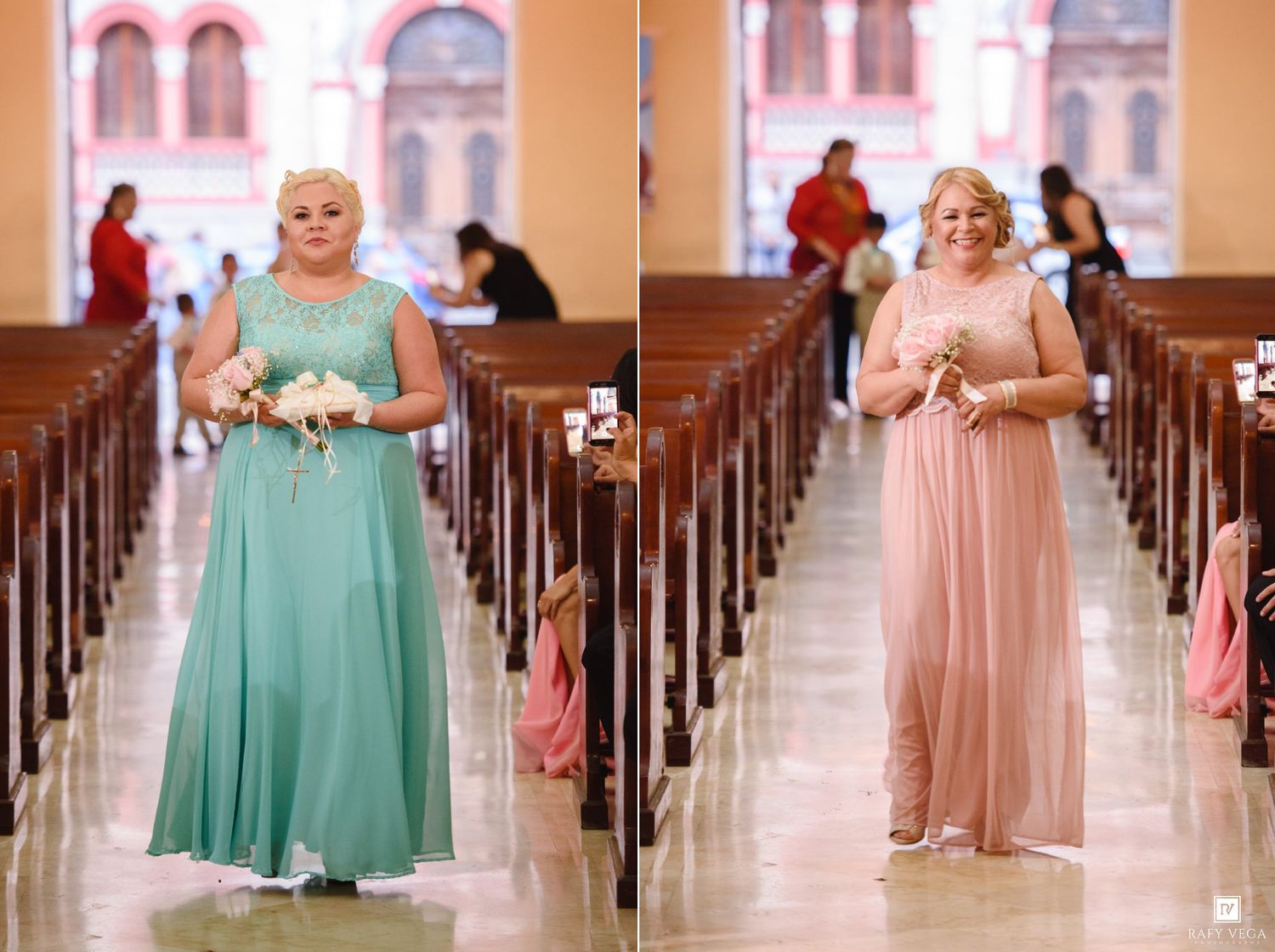 Two bridesmaids walk down a church aisle in elegant floor-length gowns, one in mint green and one in blush pink, holding bouquets.