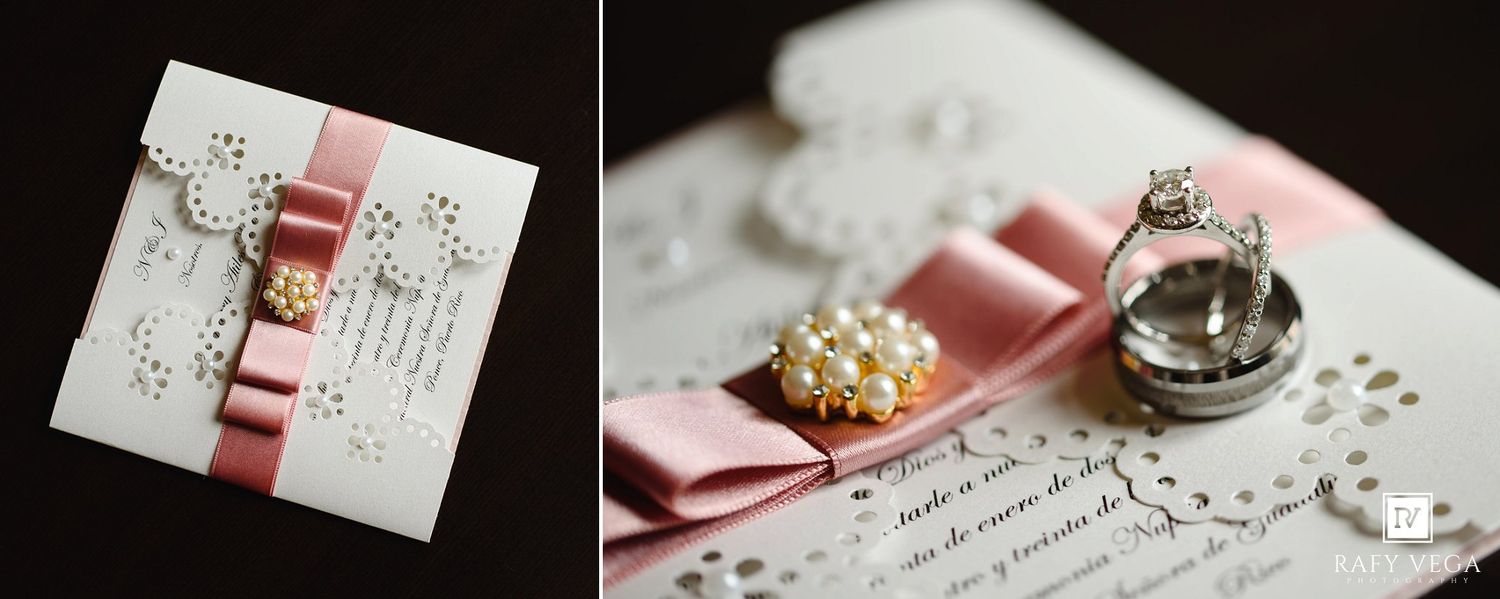 Elegant wedding invitation with pink ribbon, pearl brooch, and lace details displayed alongside diamond rings and pearl accessories.