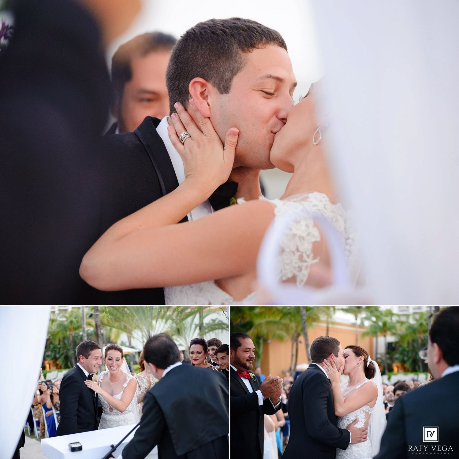 Newlyweds share their first kiss at an outdoor wedding ceremony surrounded by guests and lush greenery.