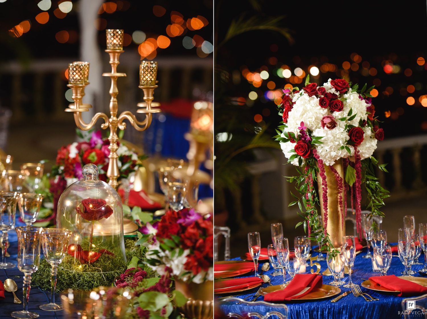 Elegant wedding tablescape with gold candelabras, red and white floral centerpieces, blue linens, and warm bokeh lights in background.