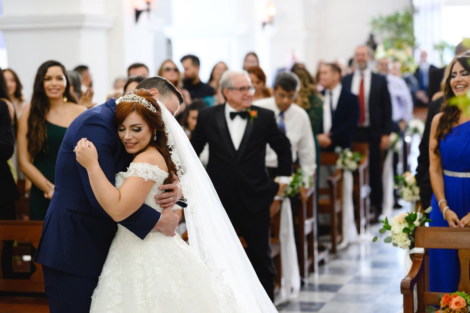 Bride and groom share a heartfelt embrace at the altar during their church wedding ceremony.
