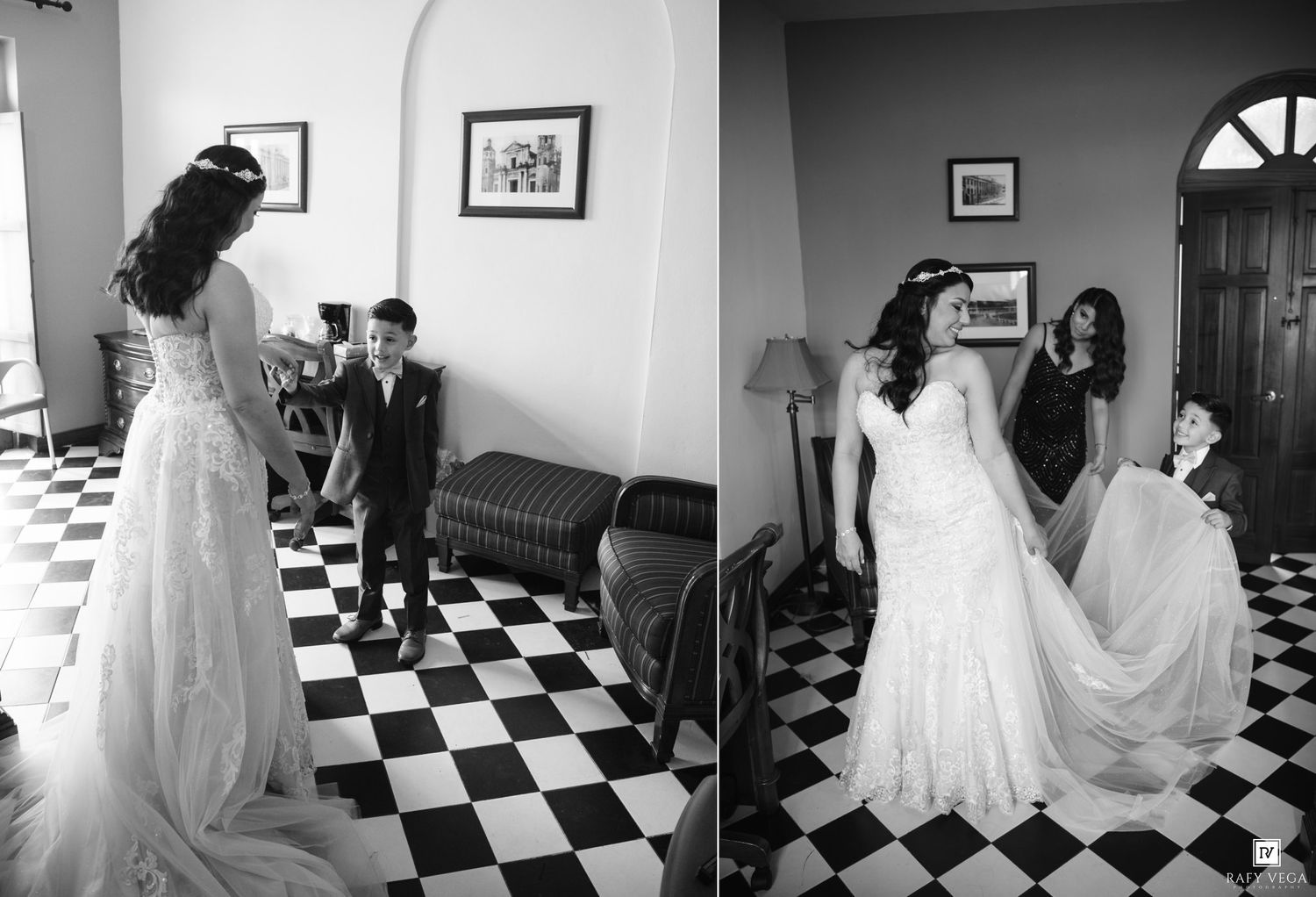 Black and white wedding photo of bride in lace gown on checkered floor with guests in elegant room.