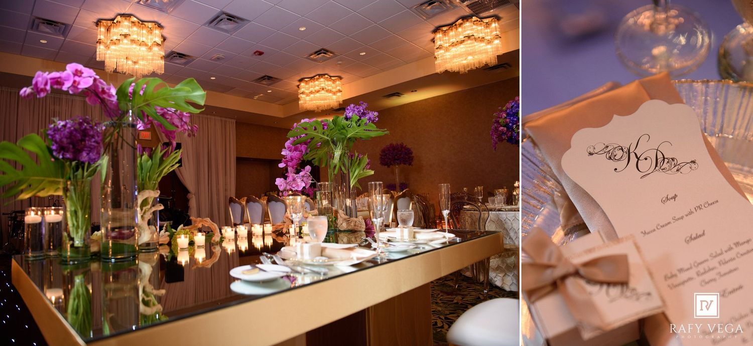 Elegant wedding reception venue with purple orchid centerpieces, mirror tables, and warm chandelier lighting.