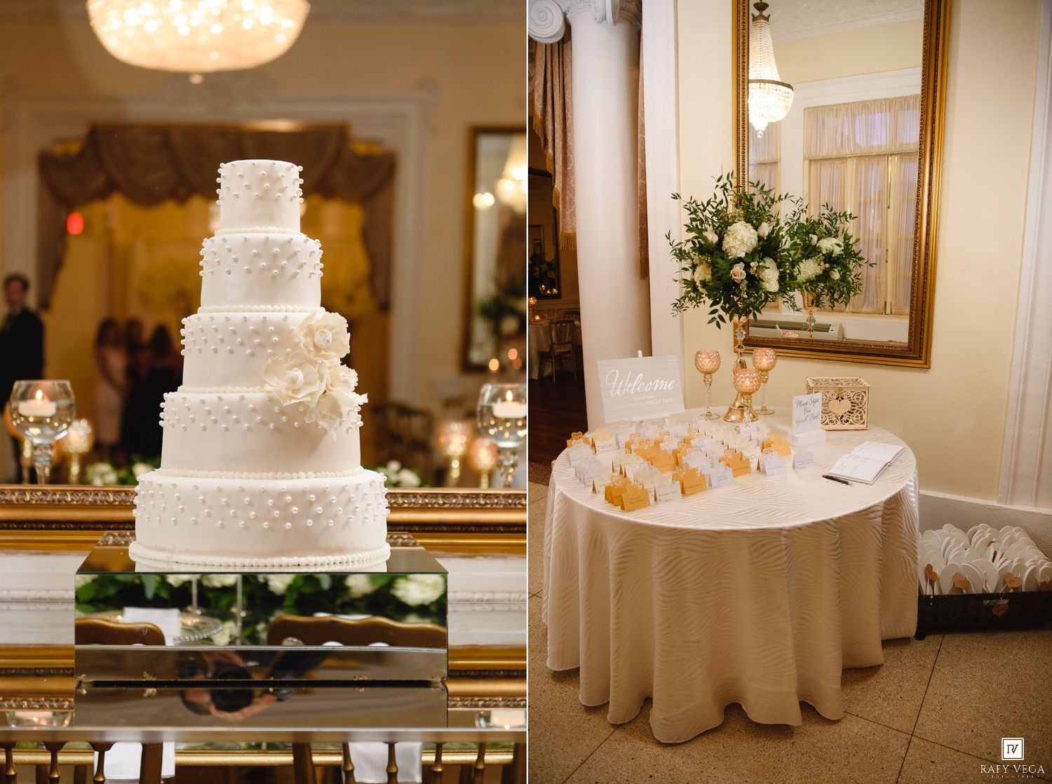Elegant wedding reception featuring a five-tier white cake and floral centerpiece on a draped table in a grand ballroom.