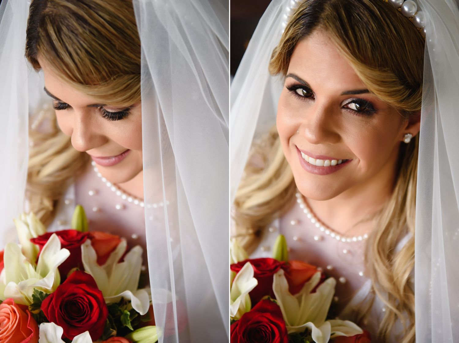 Beautiful bride wearing pearl necklace and veil smiles while holding red roses and white lily bouquet.