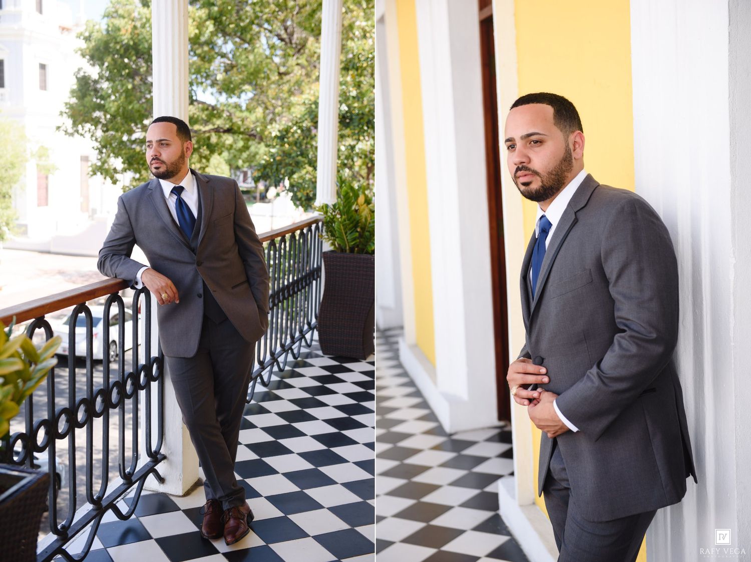 Groom in gray suit posing on a checkered floor balcony with white columns.