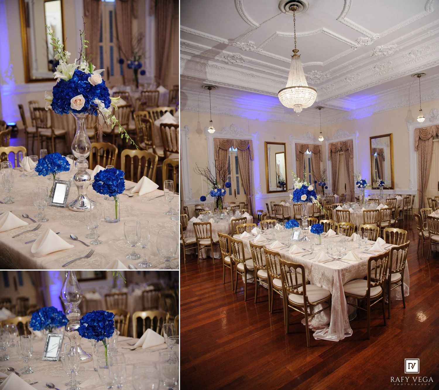 Elegant wedding reception hall with royal blue floral centerpieces, gold chairs, and crystal chandelier lighting.