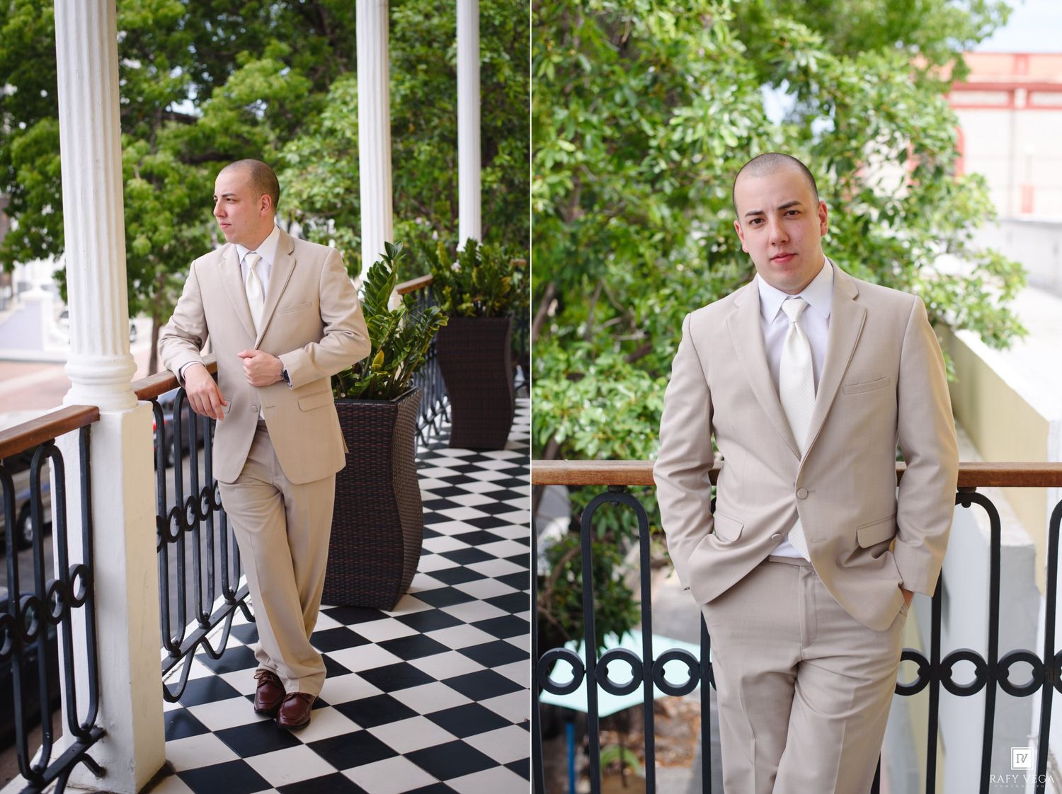 Groom in a beige suit poses on a checkered balcony with white columns and lush greenery in the background.