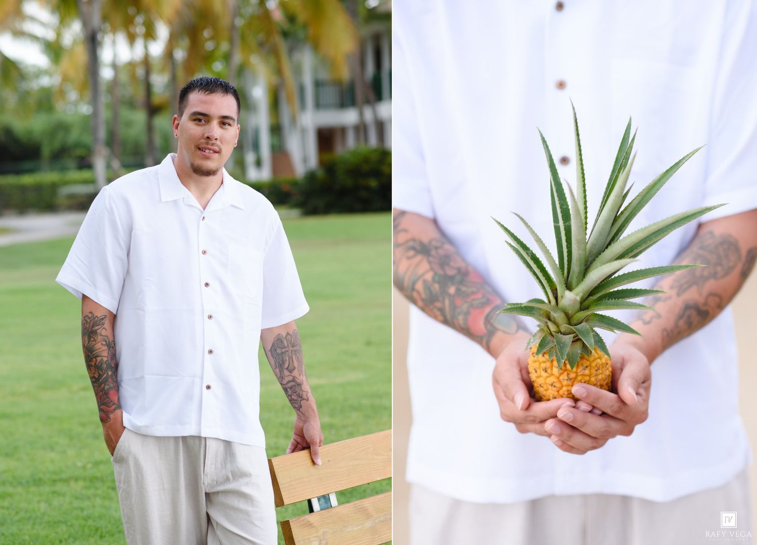 Tattooed man in white linen shirt holds mini pineapple outdoors near tropical palm trees and green lawn.