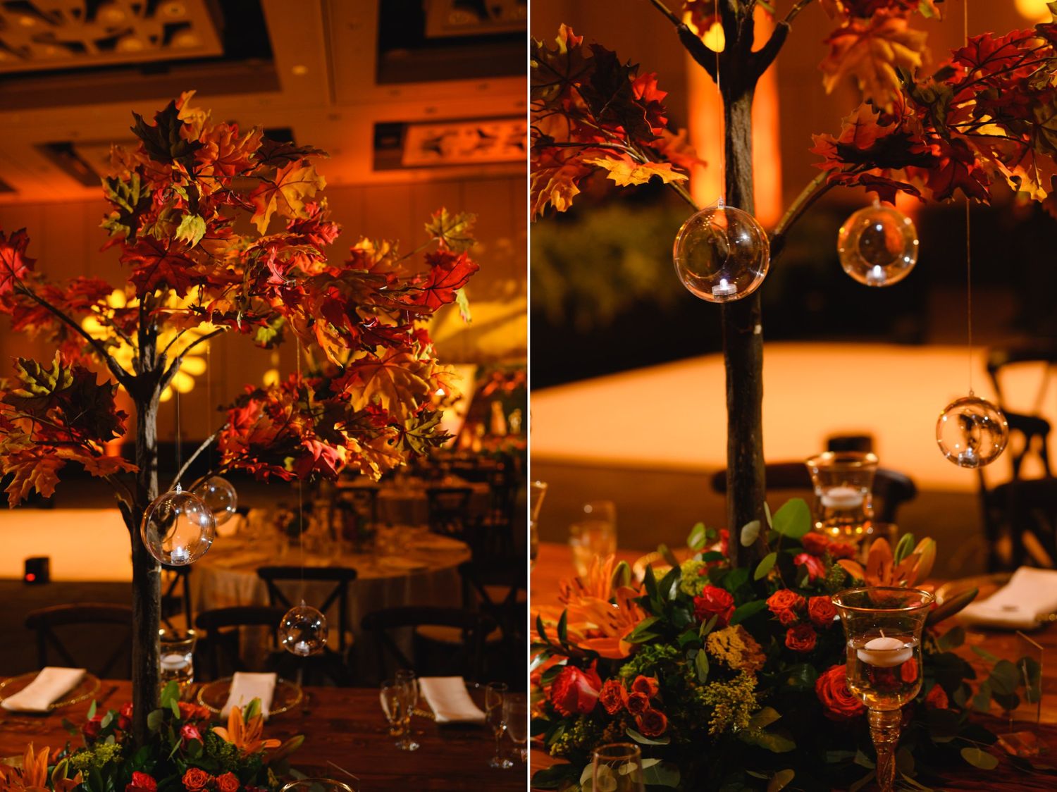 Elegant fall wedding centerpiece with autumn leaves, glowing candles, and hanging glass orbs in warm amber lighting.