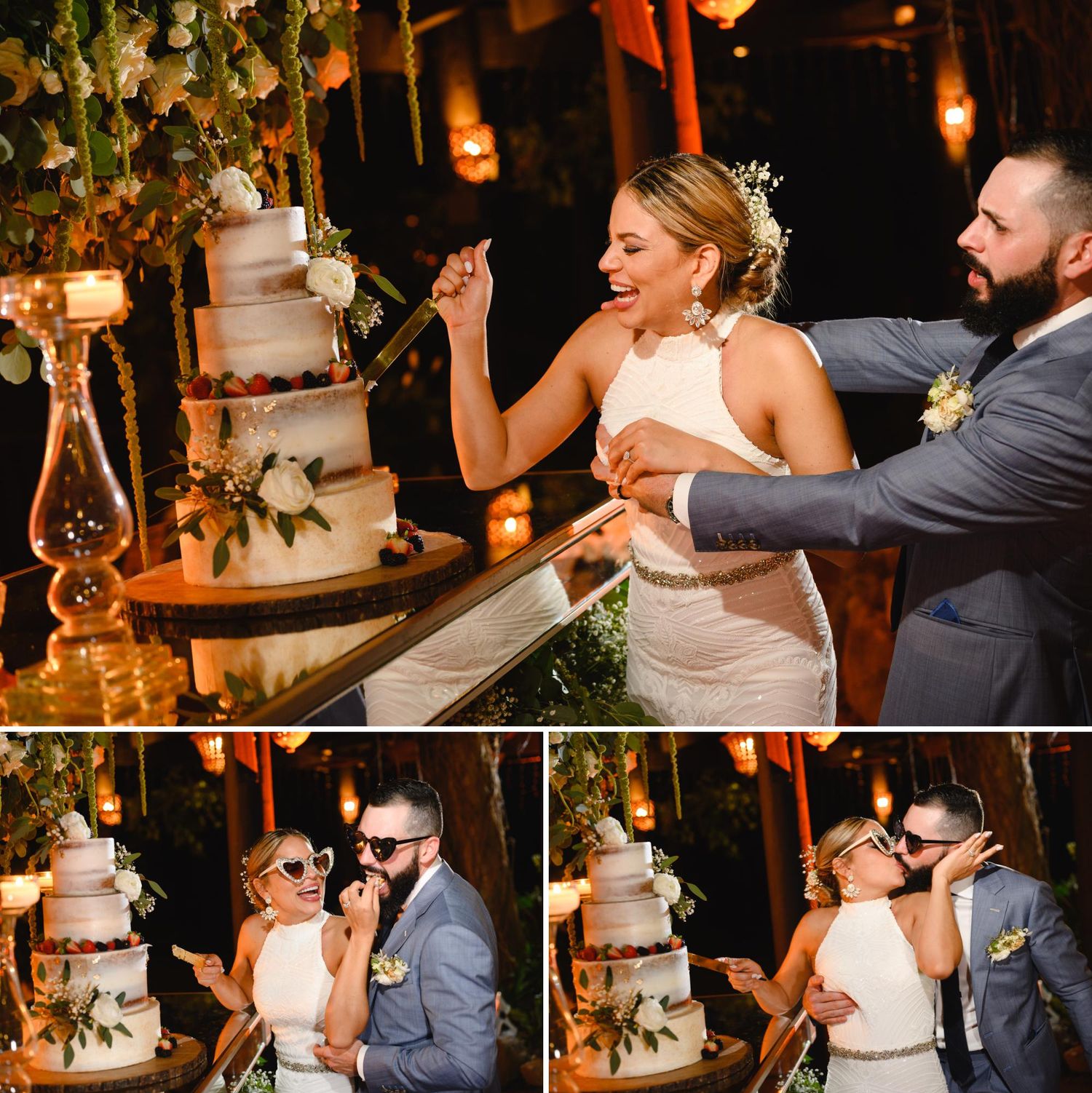 Bride and groom joyfully cutting their elegant white wedding cake at a romantic candlelit reception.