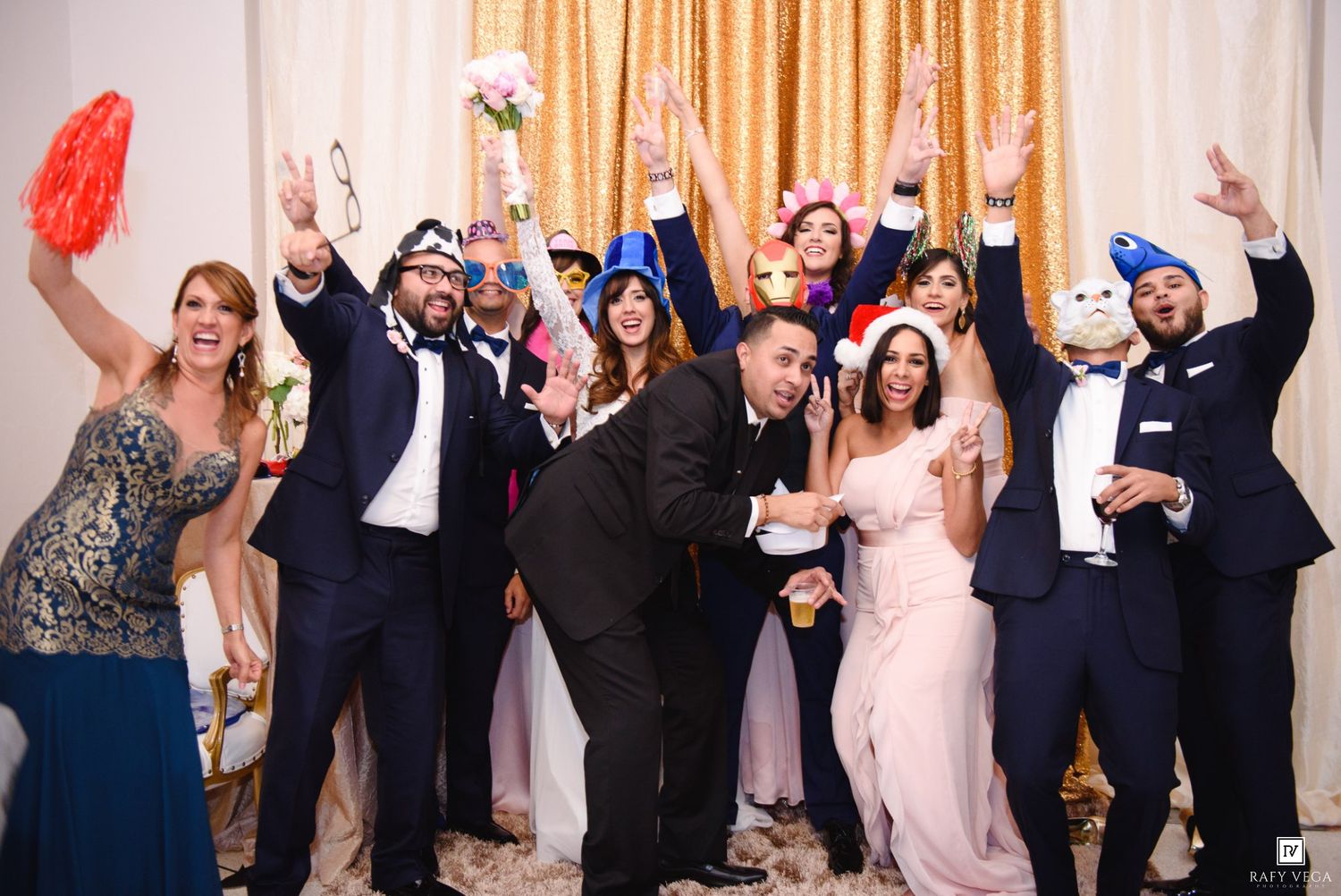 Wedding guests celebrate with fun props and costumes at a lively reception party.
