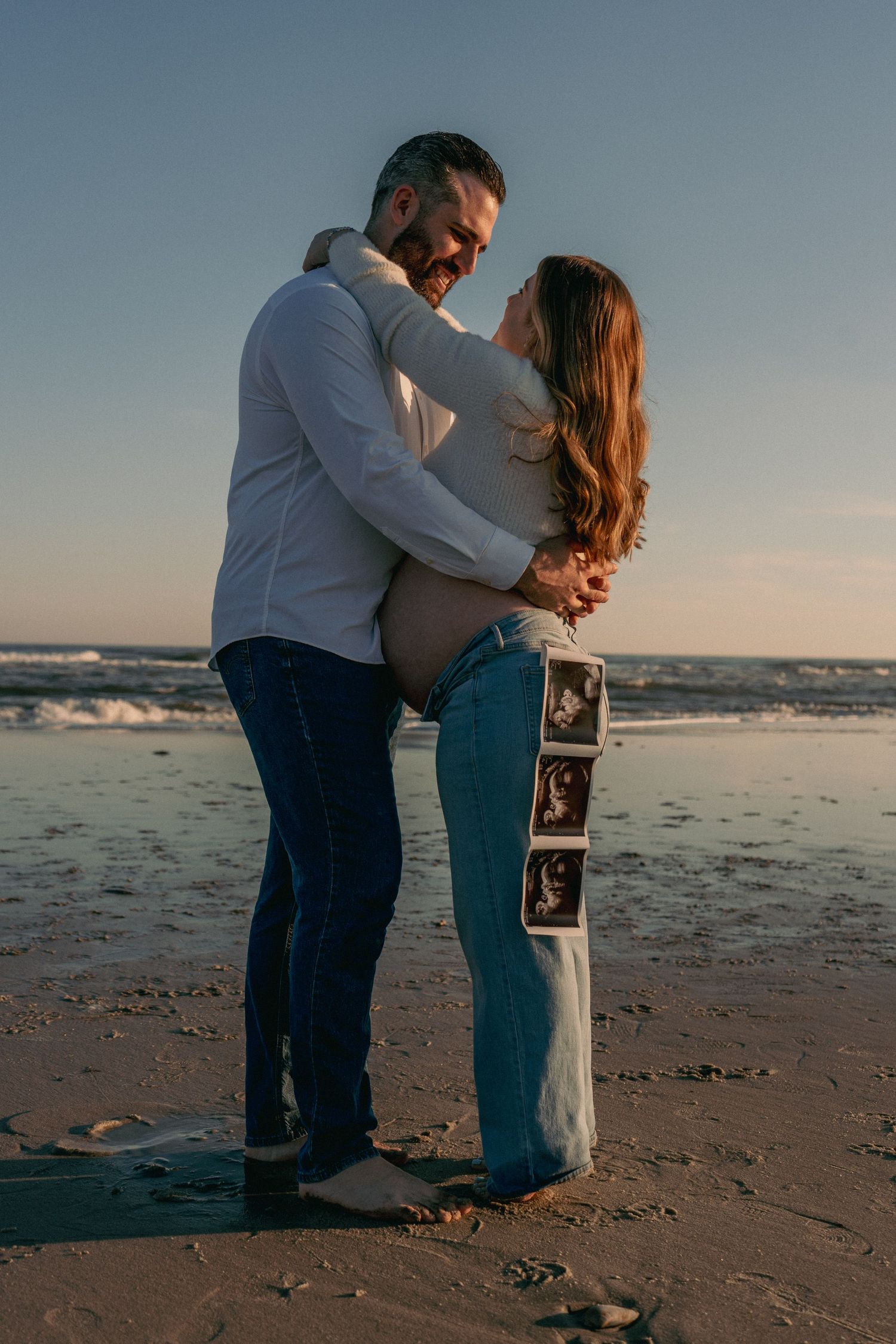 Maternity photos south jersey beach photography, couple dancing and kissing during sunset under the moon and ocean.