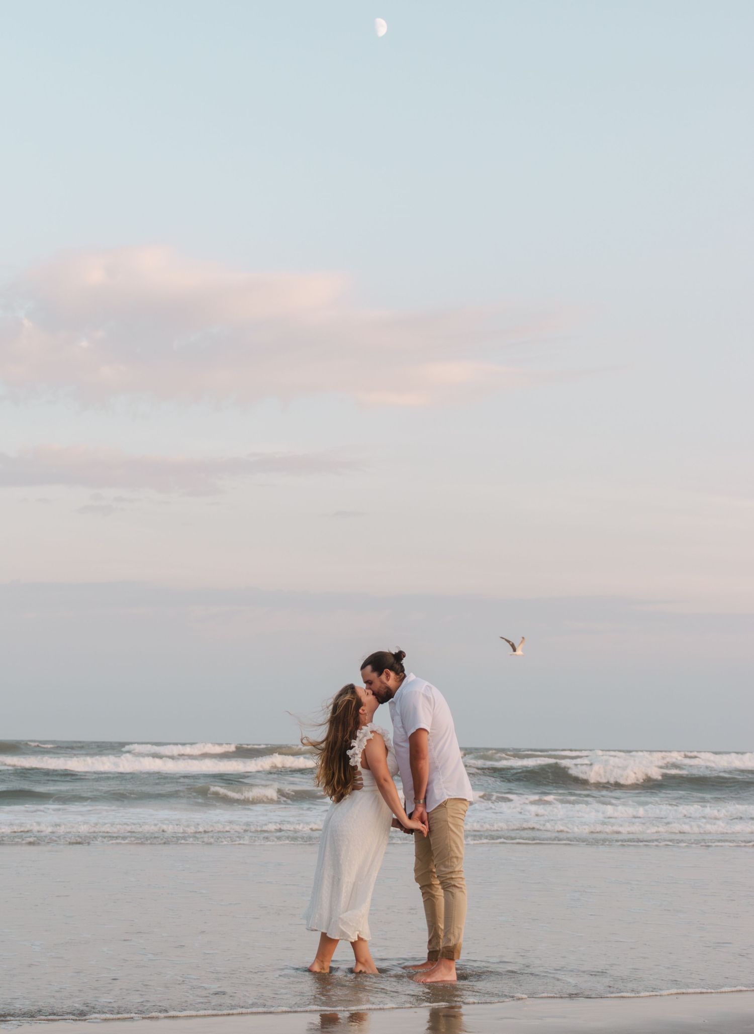 engagement photos south jersey beach photography, couple dancing and kissing during sunset under the moon and ocean.